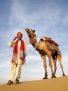 Asian Man and Camel in the Desert with Communications