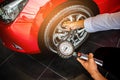 Asian man car inspection Measure quantity Inflated Rubber tires