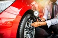 Asian man car inspection Measure quantity Inflated Rubber tires