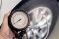 Asian man car inspection Measure quantity Inflated Rubber tires car.Close up hand holding machine Inflated pressure gauge for car Royalty Free Stock Photo