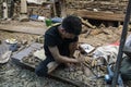 Asian man carving wood