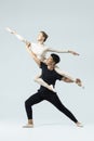 Ballet Ideas. Asian Young Man and Caucasian Woman Performing As Ballet Dancers Over Grey in Studio During Suppots As Classical Royalty Free Stock Photo