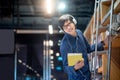 Asian man choosing book on ladder in library Royalty Free Stock Photo