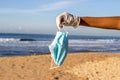 Used face mask on the beach with outdoor sun lighting. Royalty Free Stock Photo