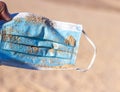 Used face mask on the beach with outdoor sun lighting. Royalty Free Stock Photo