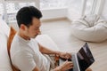 Man concentrate on his work on the laptop in his apartment. Royalty Free Stock Photo