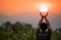 Asian man in corn field holding the sun Royalty Free Stock Photo