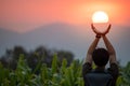 Asian man in corn field holding the sun Royalty Free Stock Photo