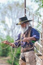 Asian Man Cowboy is catching calf To be branded in a ranch