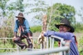 Asian Man Cowboy stands to watch the cow as brand on the ranch