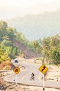 An asian man cyclist in hill climbing in the morning