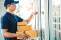 Asian man Delivery service courier Knock the door house with boxes in hands