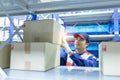 Asian man delivery staff in blue uniform work in warehouse keep goods, Auto mechanic is checking stock friendly worker in a