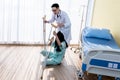 Asian man doctor Helping to support woman patient, falling dawn on the floor Near the patient`s bed