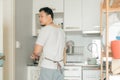 Asian man does the kitchen work. Concept of house husband clean and cook in the kitchen Royalty Free Stock Photo