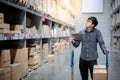 Asian man doing stocktaking on tablet in warehouse Royalty Free Stock Photo