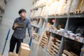 Asian man doing stocktaking on tablet in warehouse Royalty Free Stock Photo