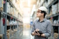 Asian man doing stocktaking by using tablet in warehouse Royalty Free Stock Photo