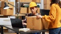 Asian man doing storage room inventory with laptop Royalty Free Stock Photo