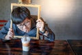 Asian man drinking milk tea through picture frame Royalty Free Stock Photo