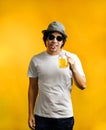 Asian Man Drinking Orange Juice Wearing Sunglasses and Fedora Ha Royalty Free Stock Photo