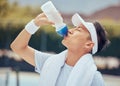 Asian man drinking water, fitness and relax after a training session, workout or exercise. Athlete, health and sports Royalty Free Stock Photo