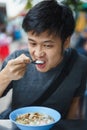 Asian man eating congree