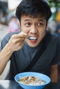 Asian man eating congree