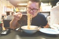 Asian man eating Instant noodles very hot and spicy