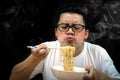 Asian man eating Instant noodles very hot and spicy