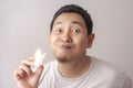 Asian Man Eating Kerupuk or Fish Crackers Royalty Free Stock Photo