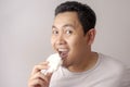 Asian Man Eating Kerupuk or Fish Crackers Royalty Free Stock Photo