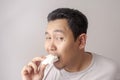 Asian Man Eating Kerupuk or Fish Crackers Royalty Free Stock Photo