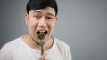 An Asian man eats broccoli. Royalty Free Stock Photo