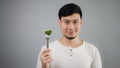 An Asian man eats broccoli. Royalty Free Stock Photo