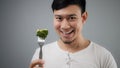 An Asian man eats broccoli. Royalty Free Stock Photo