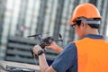 Asian man engineer adjusting drone for construction site survey Royalty Free Stock Photo
