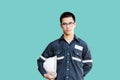 Asian man,Engineer or Technician in white helmet, glasses and bl Royalty Free Stock Photo