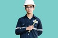 Asian man,Engineer or Technician in white helmet, glasses and bl