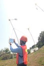 Asian man, engineer wearing a helmet Operate the wind turbine and take pictures with his phone. Ecology concepts and renewable. Royalty Free Stock Photo