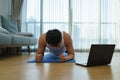 Asian men exercise at home by planking in gym closures during COVID-19 outbreak