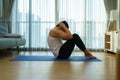 Asian man exercise at home by sit up during gym closures during COVID-19 outbreak