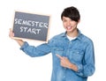 Asian man finger point to chalkboard and showing phrase of semes Royalty Free Stock Photo