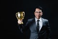 Asian man in formal suit and trophy