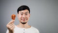 An Asian man with fried chicken. Royalty Free Stock Photo