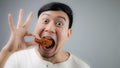 An Asian man with fried chicken. Royalty Free Stock Photo