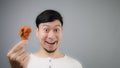 An Asian man with fried chicken. Royalty Free Stock Photo