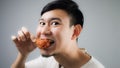 An Asian man with fried chicken. Royalty Free Stock Photo