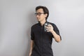 Asian man with glasses of water wearing black shirt drink fresh water