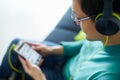 Asian Man With Green Headphones Listens Music Podcast Phone Royalty Free Stock Photo